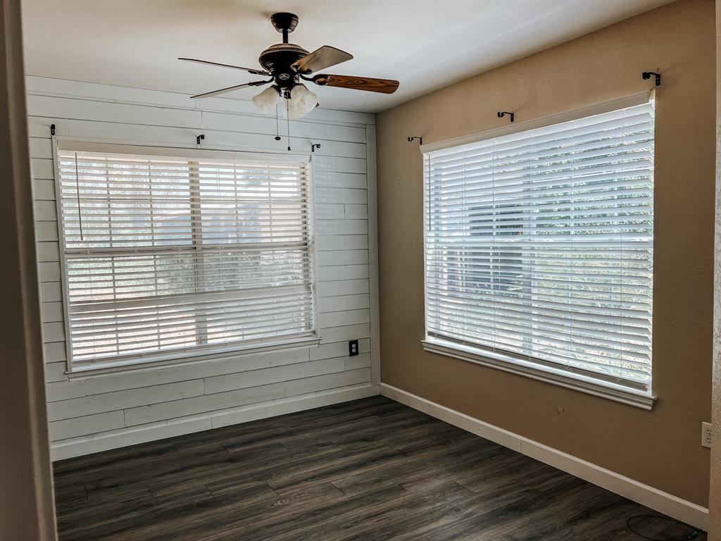 542 Goin Street Clyde, TX 79510 - Photo 5 of 7 a view of an empty room with a window and wooden floor