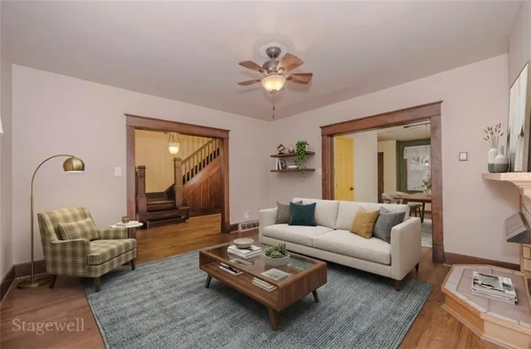 a view of an empty room with window and wooden floor