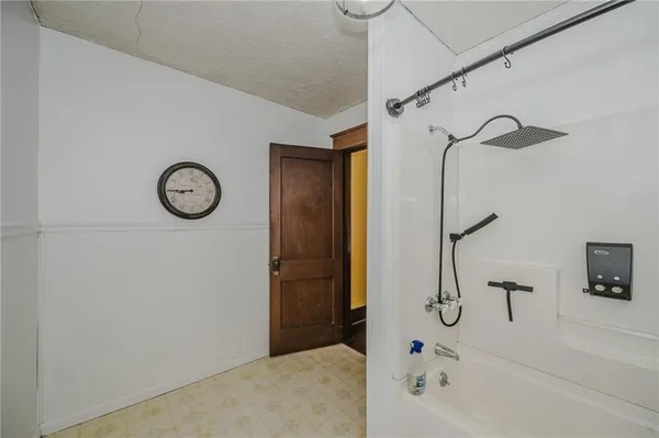 a bedroom with a bed table flowerpot and window