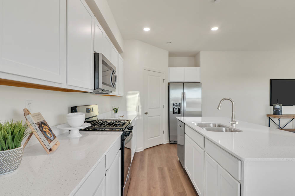 2492 Semillon Street Oswego, IL 60543 - Photo 7 of 20 a kitchen with a sink stainless steel appliances and cabinets