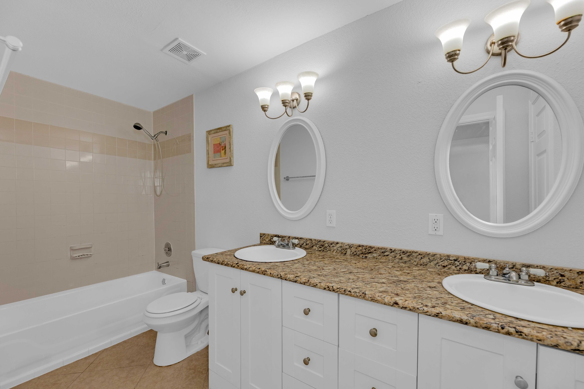 12528 Labrador Cove Austin, TX 78729 - Photo 36 of 40 Secondary Full Bathroom
Well-appointed full bathroom featuring a dual-sink vanity with granite countertops, ample storage, and updated lighting. The functional layout includes a tub and shower combination, providing both everyday convenience and flexibility. Ideally located just off the secondary bedrooms, this space enhances the home’s layout and creates a comfortable and private guest-ready setup.