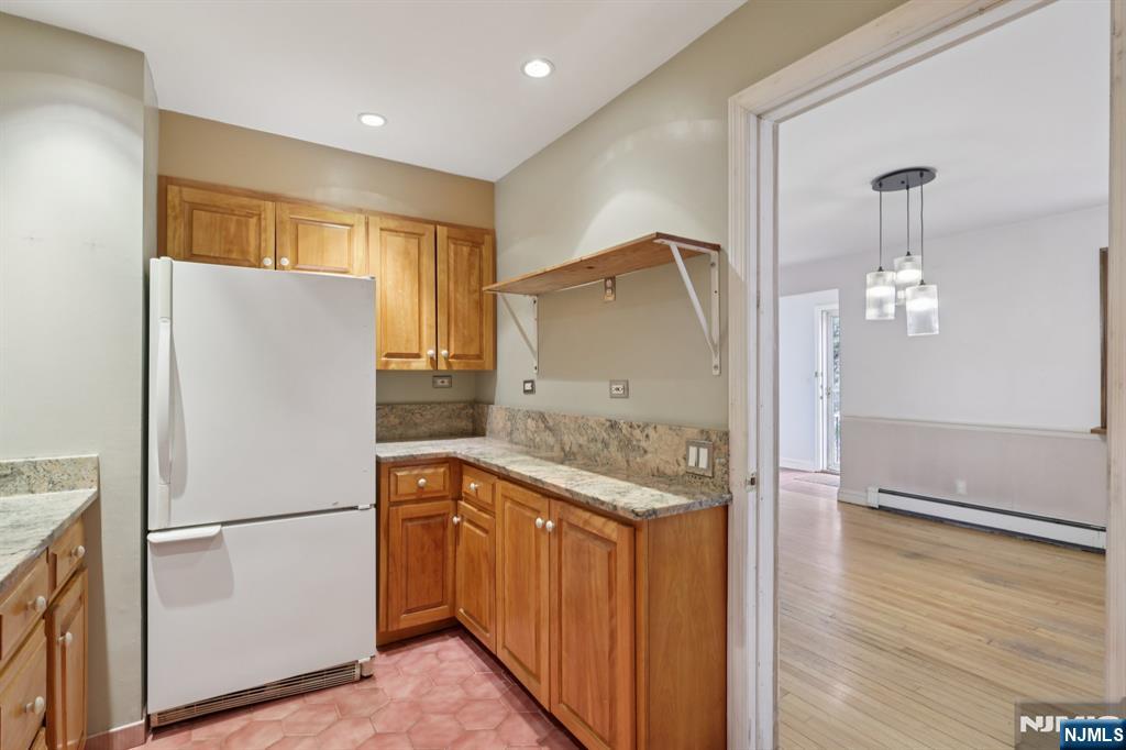 27 Jagoe Street Bergenfield, NJ 07621 - Photo 13 of 44 a white refrigerator freezer sitting inside of a kitchen