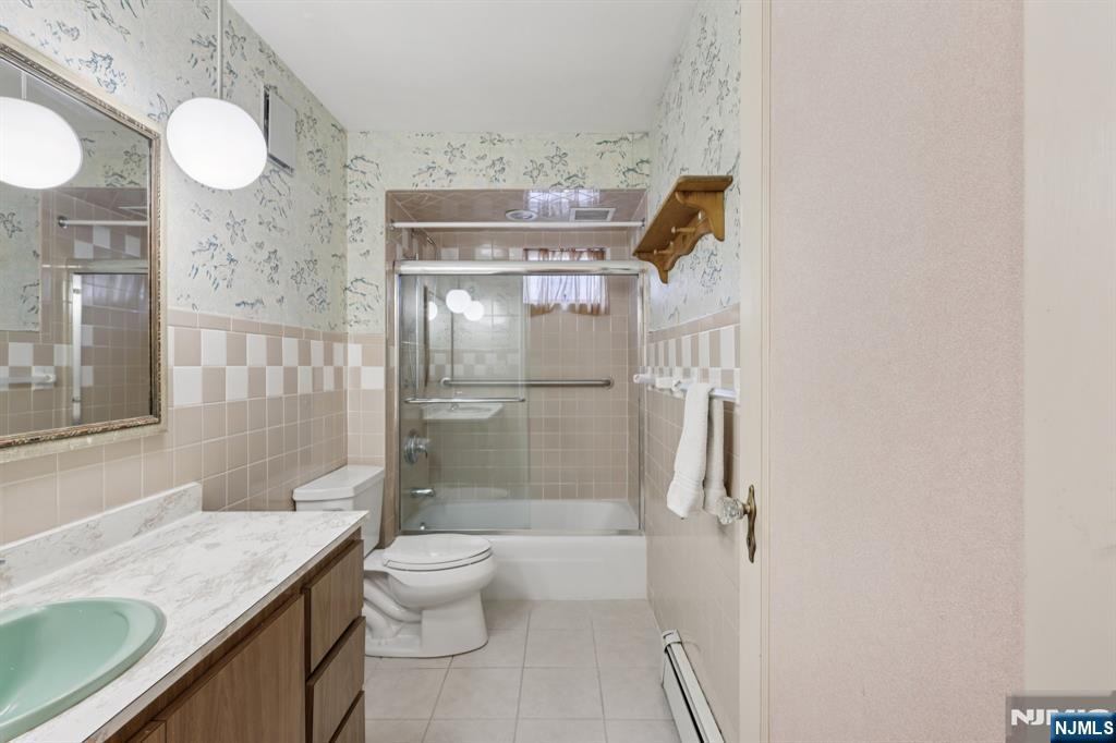 27 Jagoe Street Bergenfield, NJ 07621 - Photo 15 of 44 a bathroom with a granite countertop sink mirror vanity and toilet