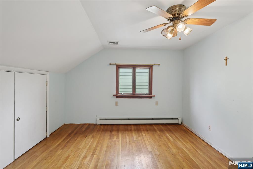 27 Jagoe Street Bergenfield, NJ 07621 - Photo 26 of 44 wooden floor in an empty room with a window