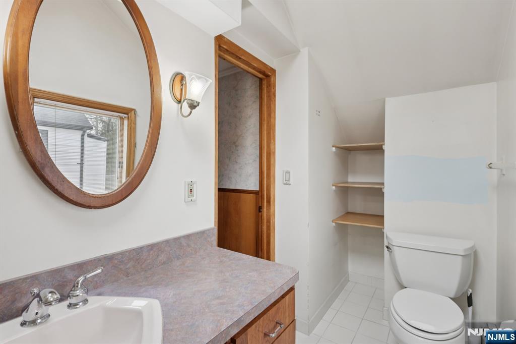 27 Jagoe Street Bergenfield, NJ 07621 - Photo 36 of 44 a bathroom with a toilet a sink and a mirror