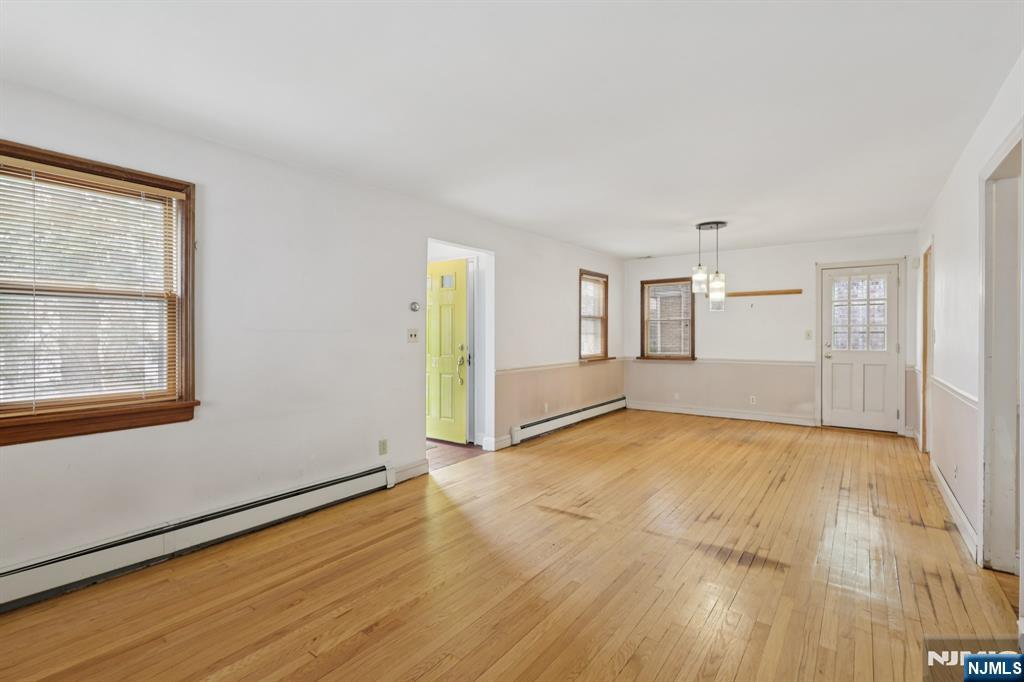 27 Jagoe Street Bergenfield, NJ 07621 - Photo 6 of 44 a view of an empty room with window and wooden floor