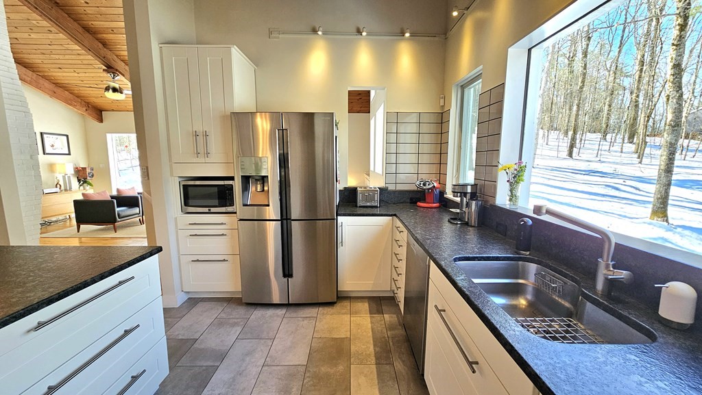 28 Butterhill Road Pelham, MA 01002 - Photo 15 of 42 a kitchen with stainless steel appliances granite countertop a sink a stove and a refrigerator