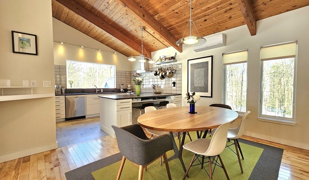 28 Butterhill Road Pelham, MA 01002 - Photo 10 of 42 a kitchen with a dining table and chairs