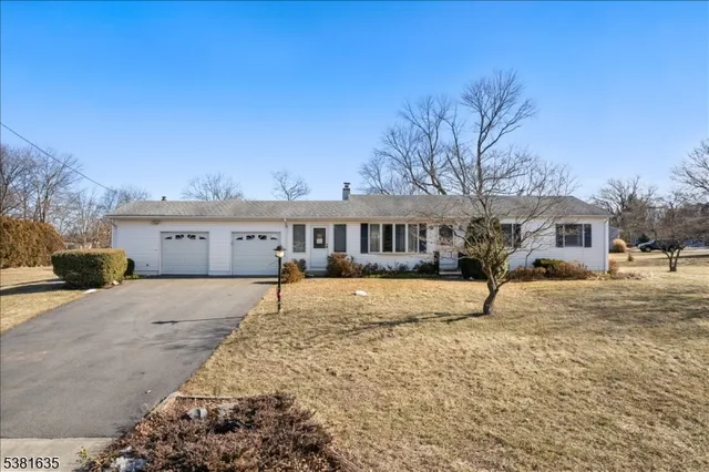 a front view of house with yard covered in snow