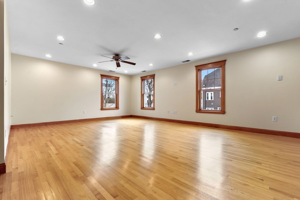 50 Maple Street, Unit 5 Danvers, MA 01923 - Photo 12 of 21 a view of empty room with wooden floor and fan