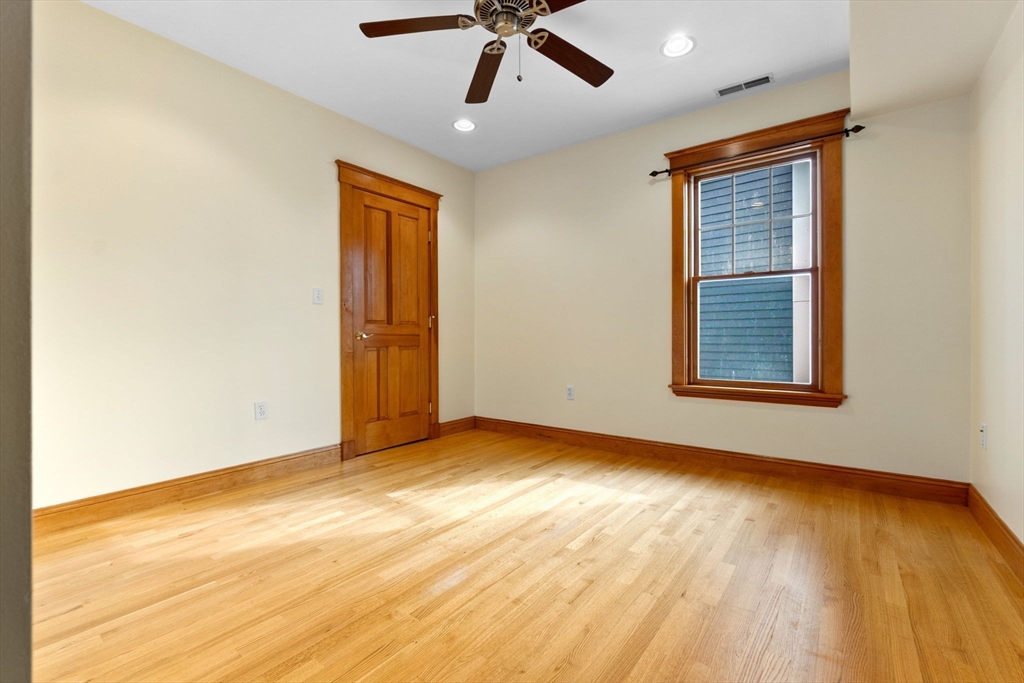 50 Maple Street, Unit 5 Danvers, MA 01923 - Photo 13 of 21 a view of an empty room with wooden floor and a window