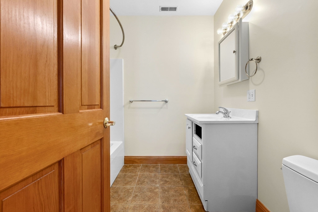 50 Maple Street, Unit 5 Danvers, MA 01923 - Photo 16 of 21 a bathroom with a sink a toilet and shower