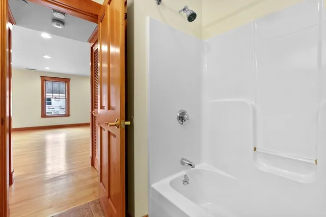 a bathroom with a tub and shower