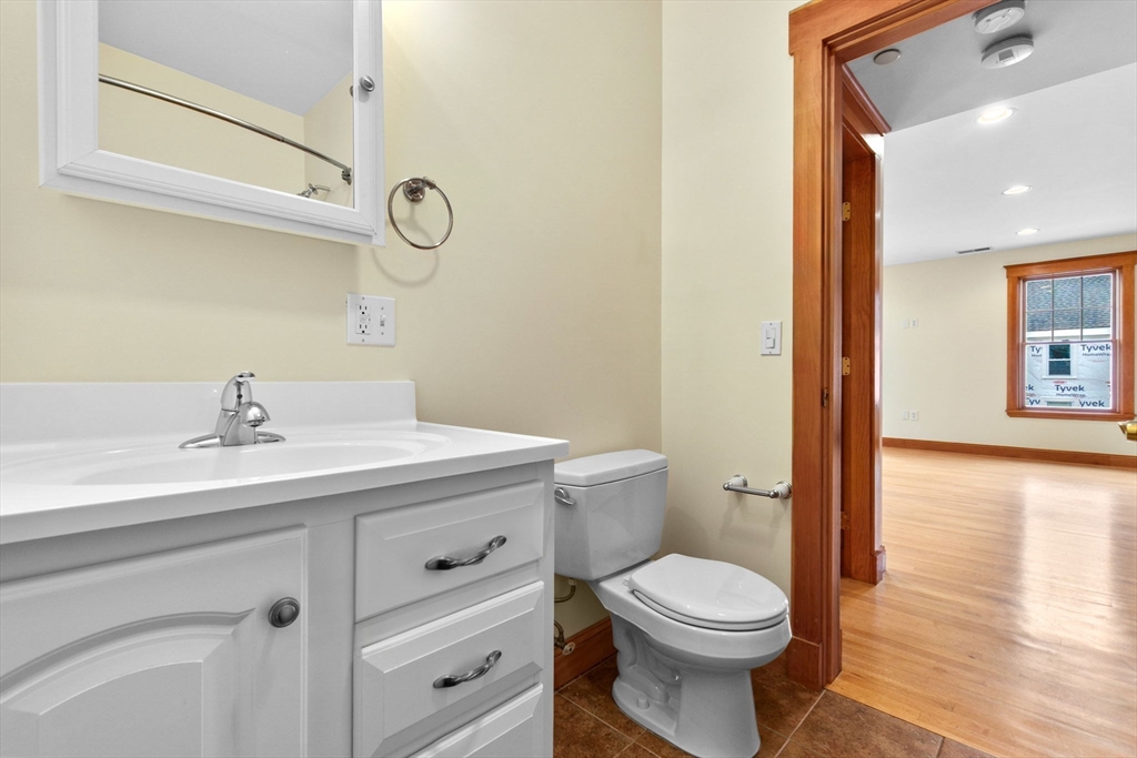 50 Maple Street, Unit 5 Danvers, MA 01923 - Photo 18 of 21 a bathroom with a toilet a sink and mirror