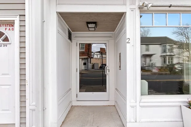 a view of a hallway with a glass door and a window