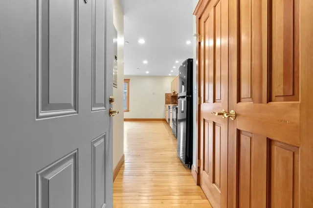 a view of a hallway with a window and a mirror