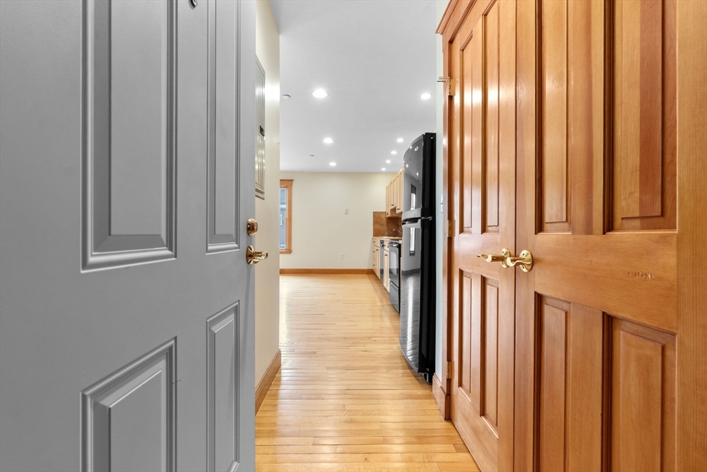 50 Maple Street, Unit 5 Danvers, MA 01923 - Photo 4 of 21 a view of a hallway with a window and a mirror
