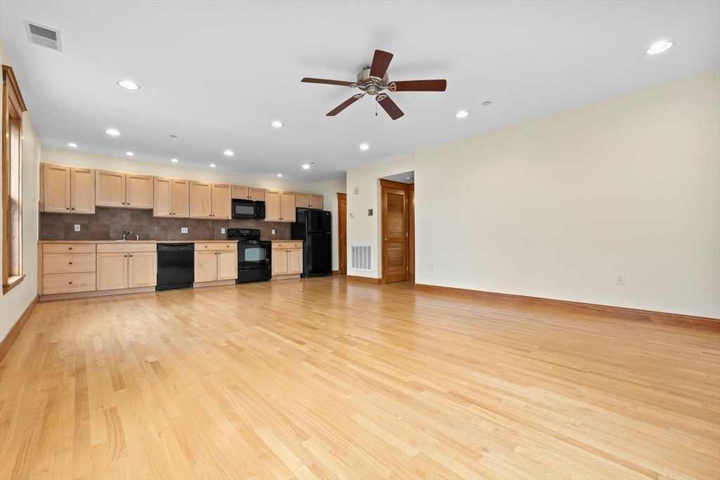 50 Maple Street, Unit 5 Danvers, MA 01923 - Photo 8 of 21 a view of a kitchen with a refrigerator and a stove top oven