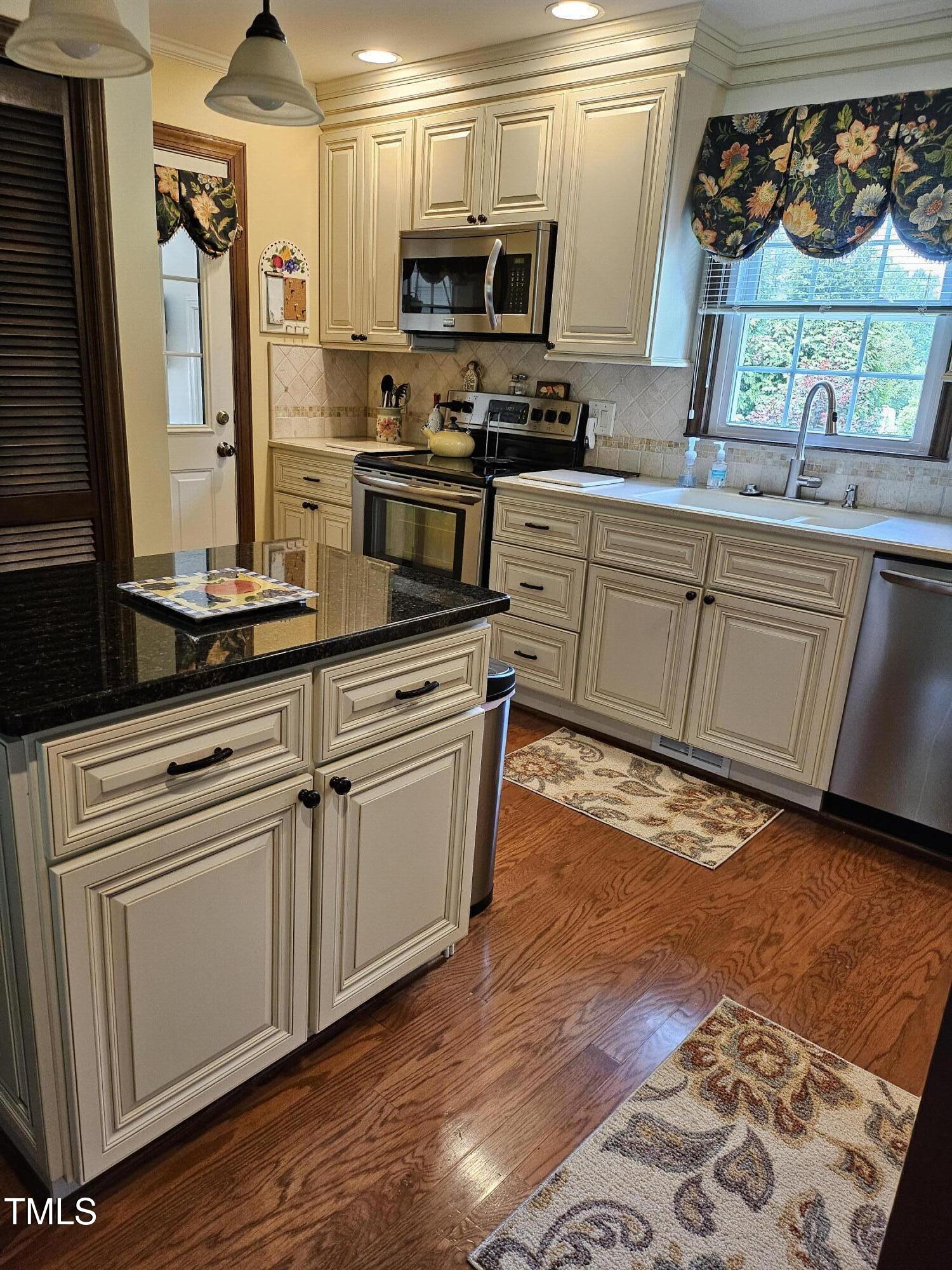 2000 Howson Road Raleigh, NC 27603 - Photo 8 of 43 a kitchen with stainless steel appliances granite countertop a stove a sink and a microwave