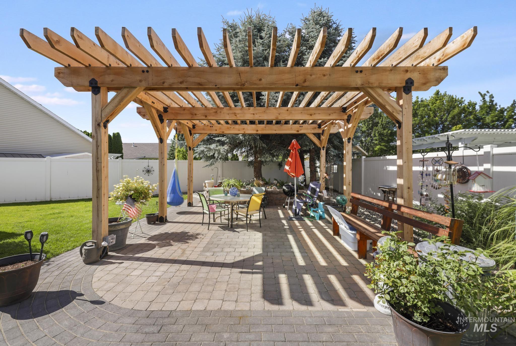 467 Wildrose Loop Twin Falls, ID 83301 - Photo 36 of 46 Expansive patio featuring a custom wood pergola, paver stone flooring, and a privacy fence