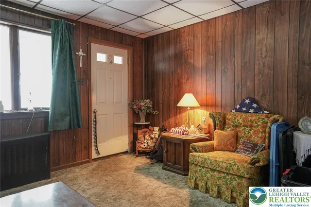 a living room with furniture a large window and a fireplace