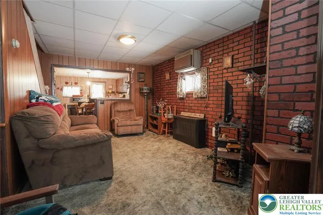a living room with furniture a flat screen tv and a window