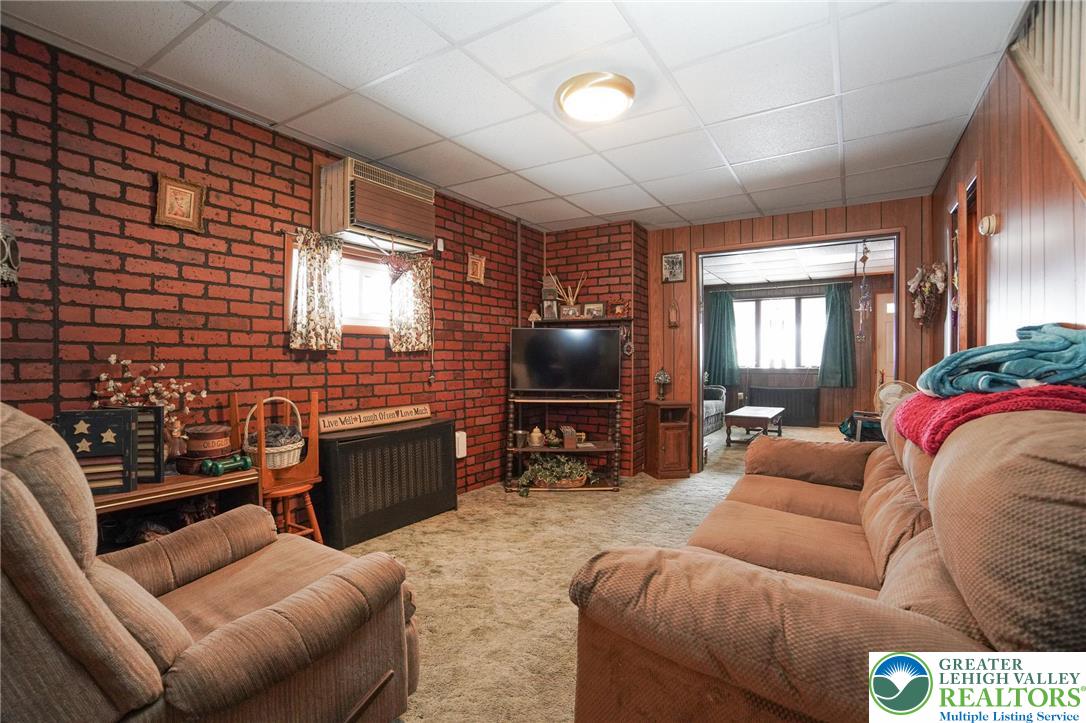 335 West Patterson Street Lansford, PA 18232 - Photo 16 of 32 a living room with furniture a flat screen tv and a window