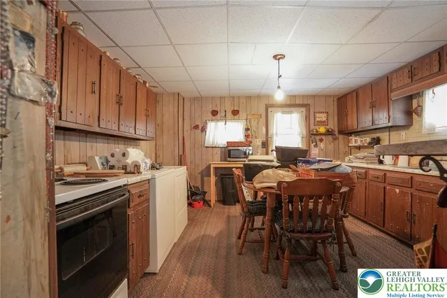a kitchen with a dining table chairs and a sink