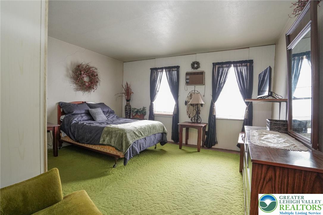 335 West Patterson Street Lansford, PA 18232 - Photo 23 of 32 a spacious bedroom with a bed and window