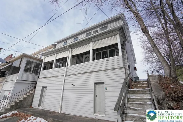 a view of a dinning table and chairs in the patio of snow
