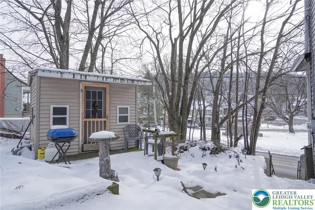 a view of house with backyard and sitting area