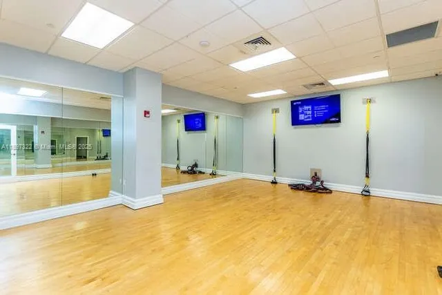 a view of a patio with a table and chairs and potted plants