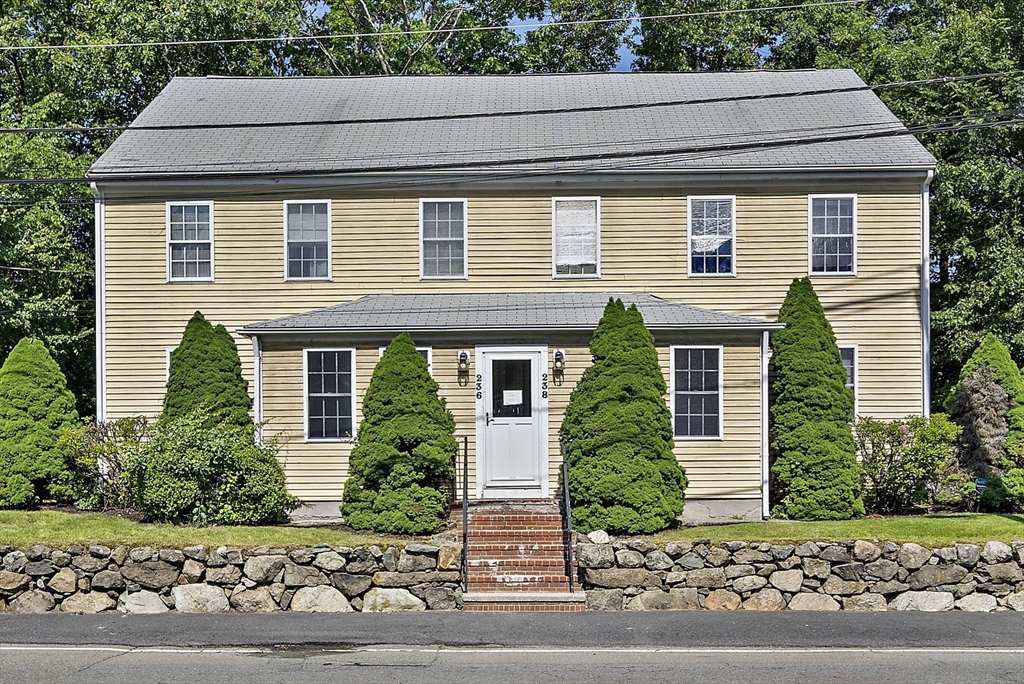 236 Neponset Street, Unit 2 Canton, MA 02021 - Photo 1 of 1 a front view of a house with a yard and garage