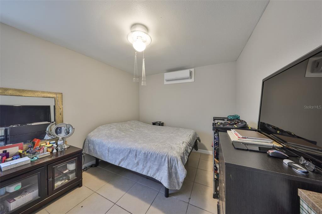 11708 Balm Riverview Road Riverview, FL 33569 - Photo 11 of 37 a bedroom with a bed and a flat screen tv