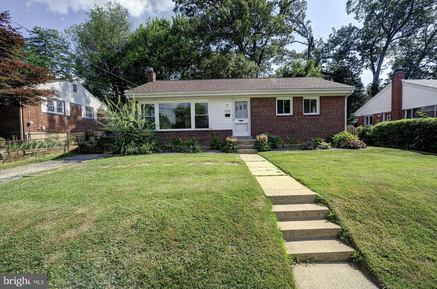 a view of a house with a yard and plants