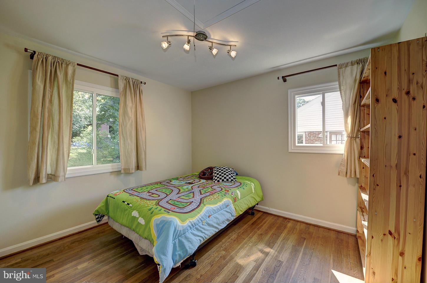 2908 Harris Avenue Silver Spring, MD 20902 - Photo 13 of 30 a bedroom with a bed and wooden floor