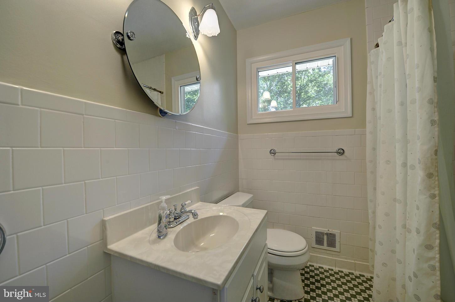 2908 Harris Avenue Silver Spring, MD 20902 - Photo 15 of 30 a bathroom with a sink toilet and a mirror