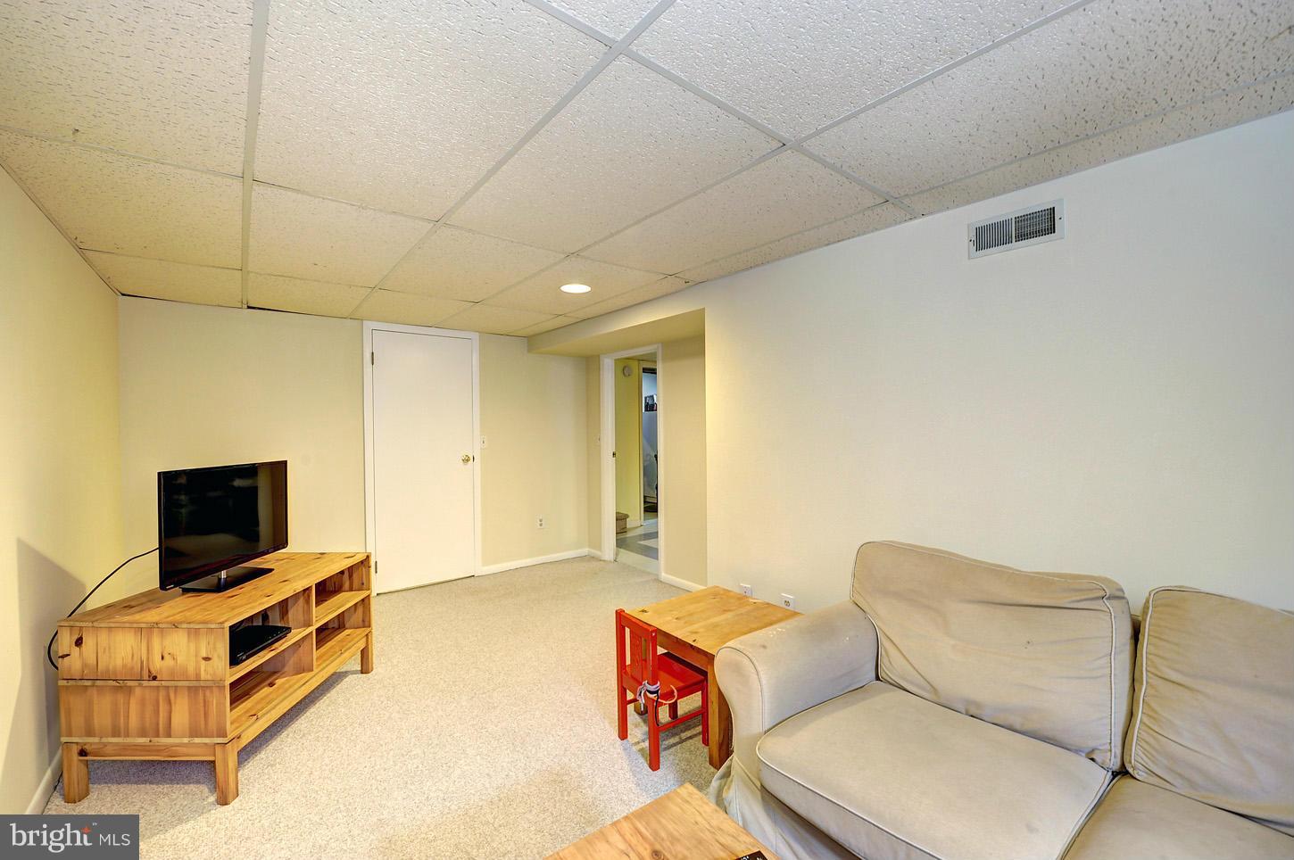2908 Harris Avenue Silver Spring, MD 20902 - Photo 20 of 30 a living room with furniture and a flat screen tv