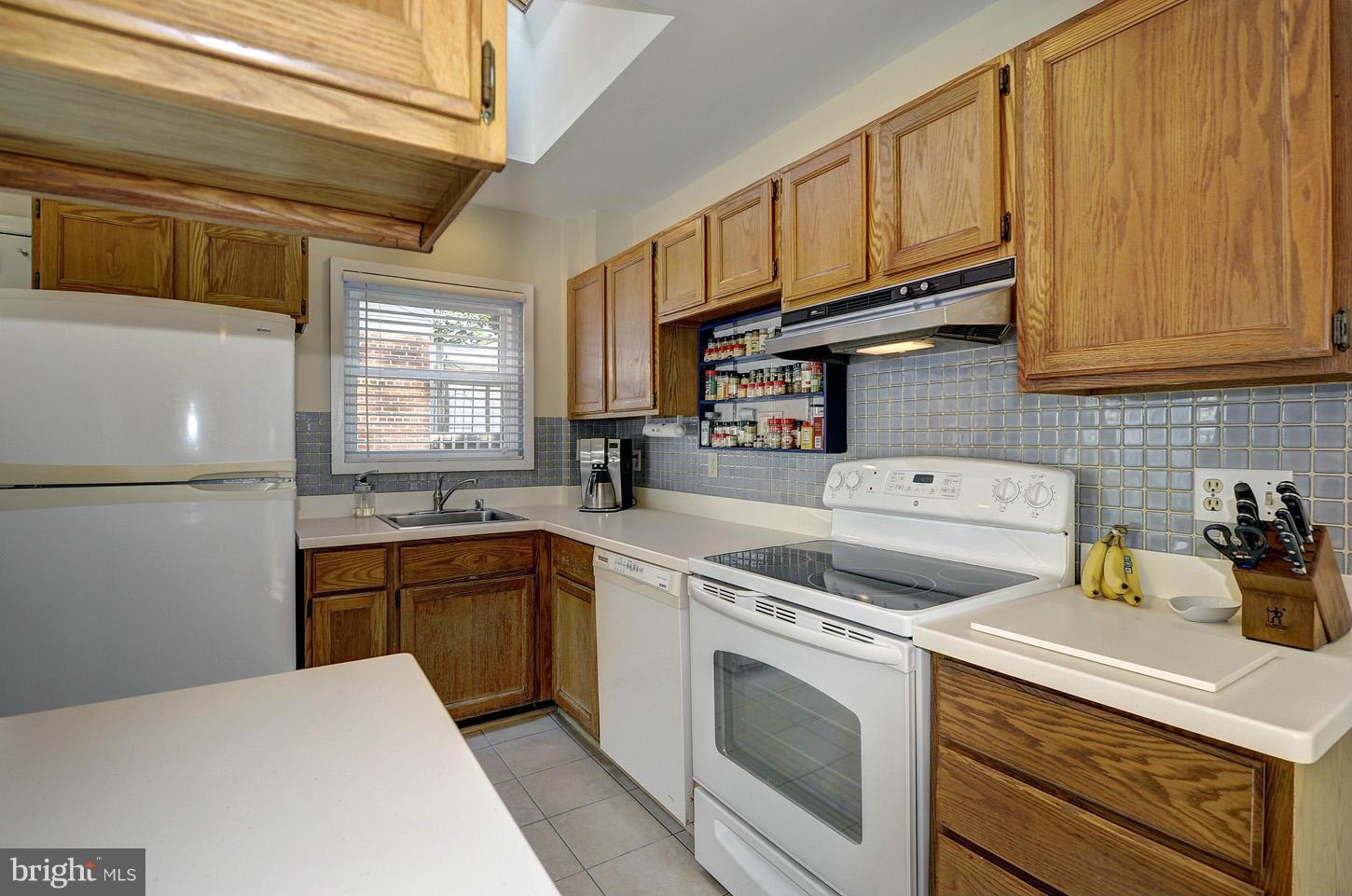 2908 Harris Avenue Silver Spring, MD 20902 - Photo 7 of 30 a kitchen with stainless steel appliances granite countertop a sink a stove and cabinets