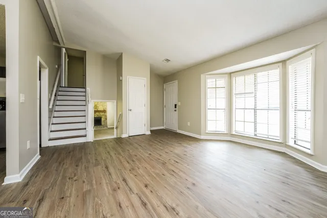 a kitchen with a refrigerator and a stove top oven