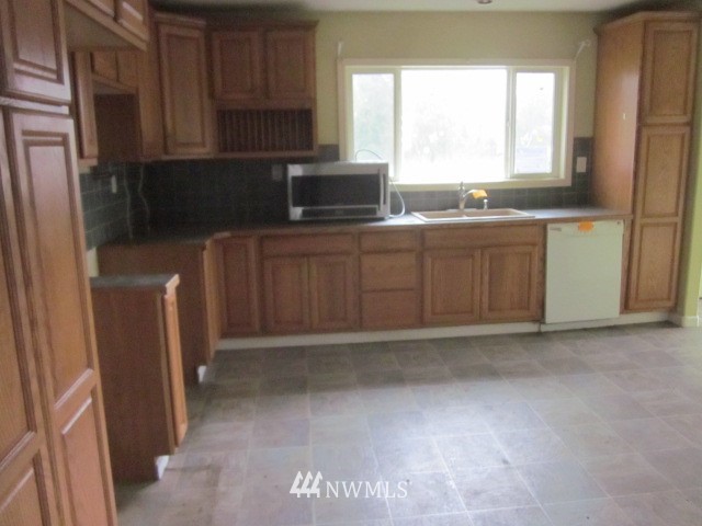 378 Boistfort Road Curtis, WA 98538 - Photo 5 of 18 a kitchen with sink a window and appliances
