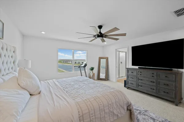 a bedroom with a baby bed dresser and a window
