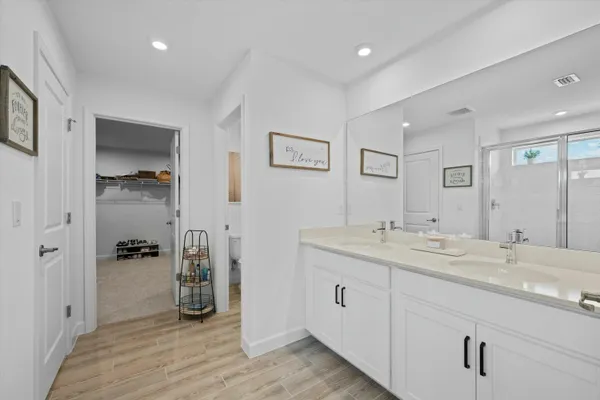 a bathroom with a granite countertop sink a toilet and a shower
