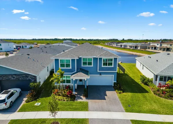 an aerial view of a house with a yard