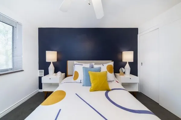 a living room with furniture and a lamp