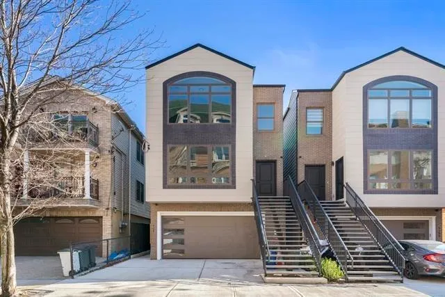 a front view of a house with large windows
