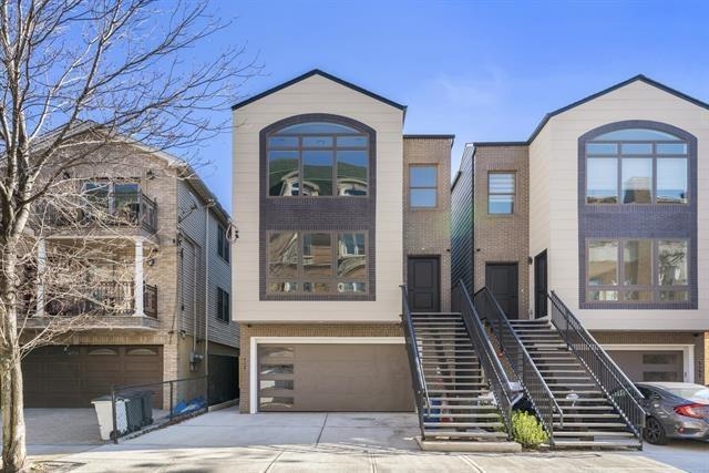 6110 Fillmore Place, Unit 1 West New York, NJ 07093 - Photo 1 of 7 a front view of a house with large windows