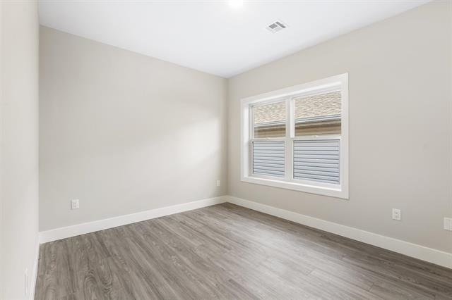 6110 Fillmore Place, Unit 1 West New York, NJ 07093 - Photo 5 of 7 a view of an empty room with wooden floor and a window