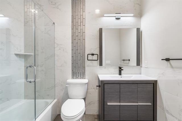 6110 Fillmore Place, Unit 1 West New York, NJ 07093 - Photo 6 of 7 a bathroom with a sink toilet and shower