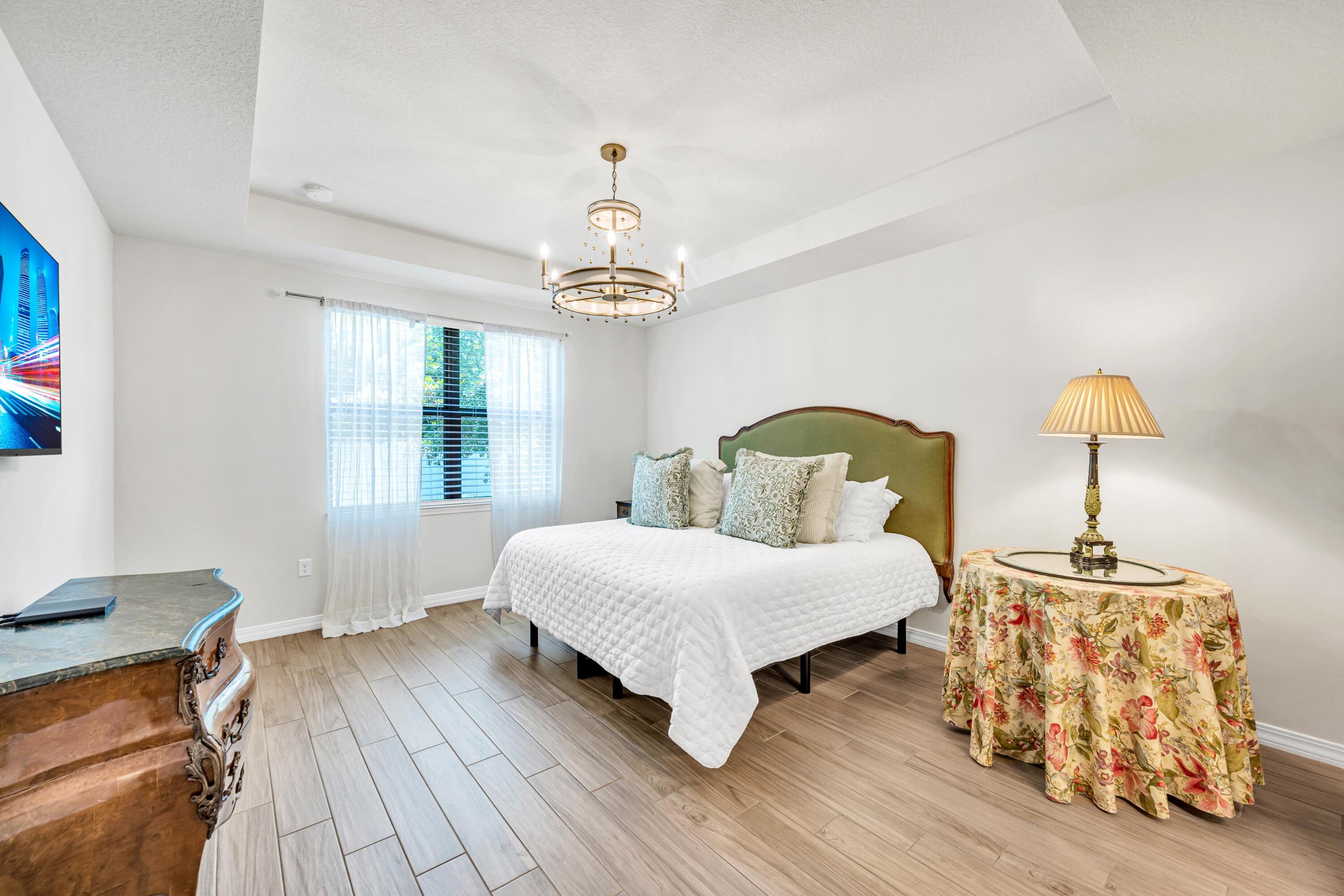 8028 Northwest 78th Street Tamarac, FL 33321 - Photo 11 of 38 a bedroom with a bed and wooden floor
